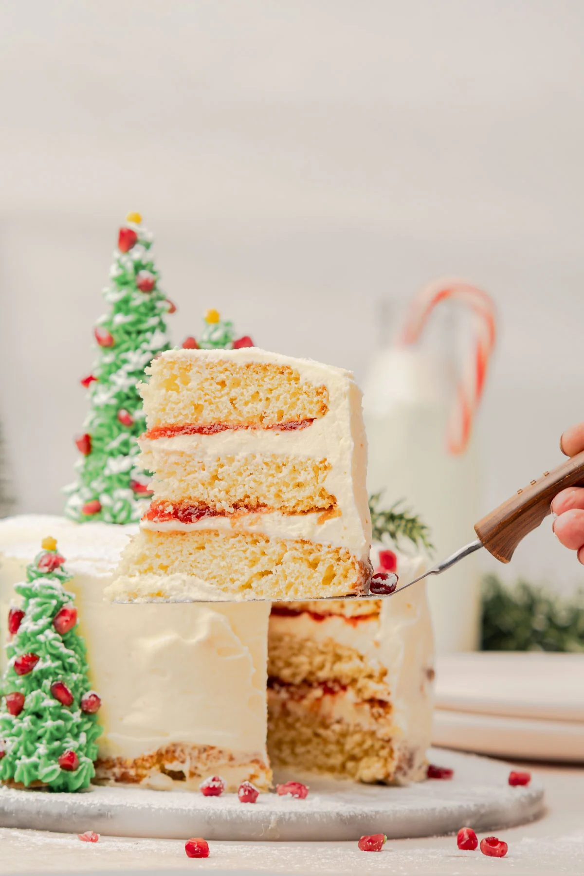 woman's hand holding a slice of cake on a spatula