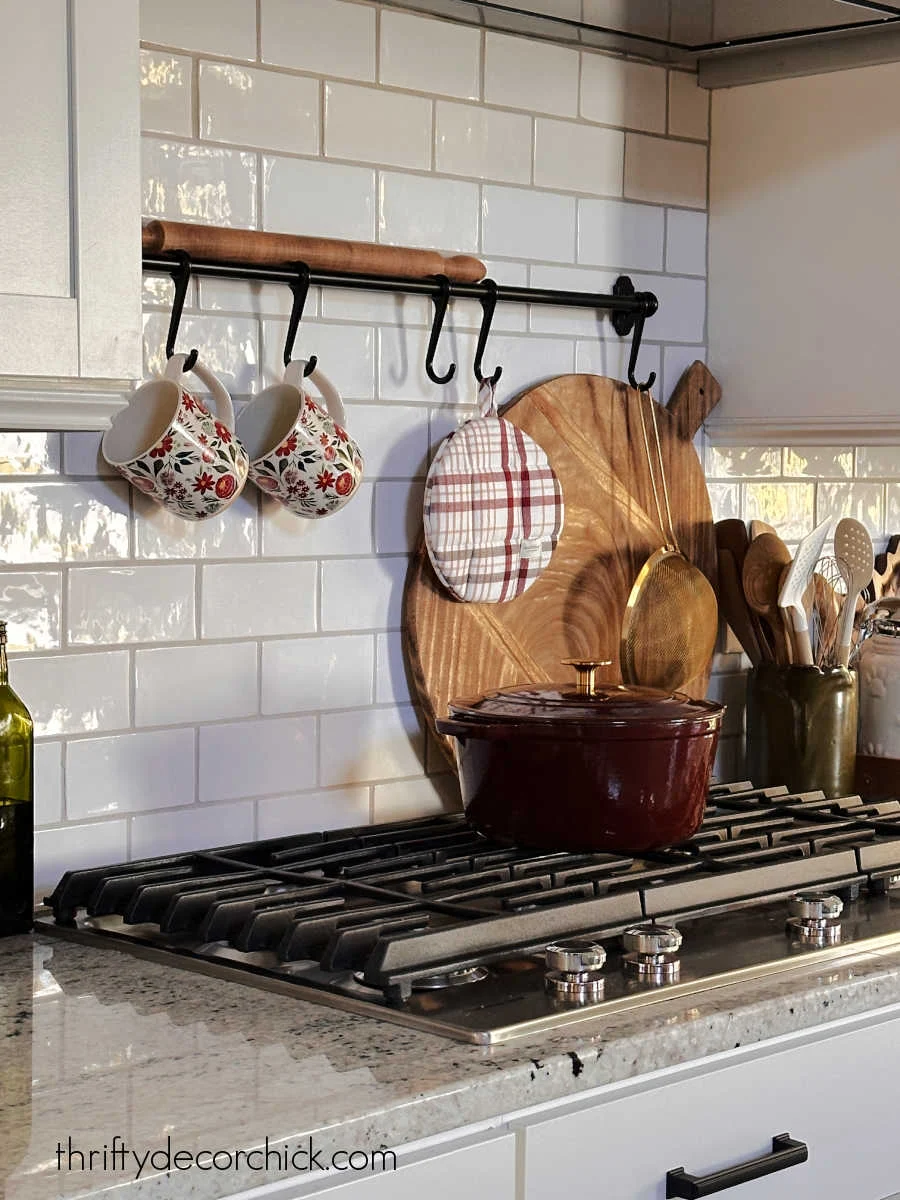 decorative bar with hooks over stovetop
