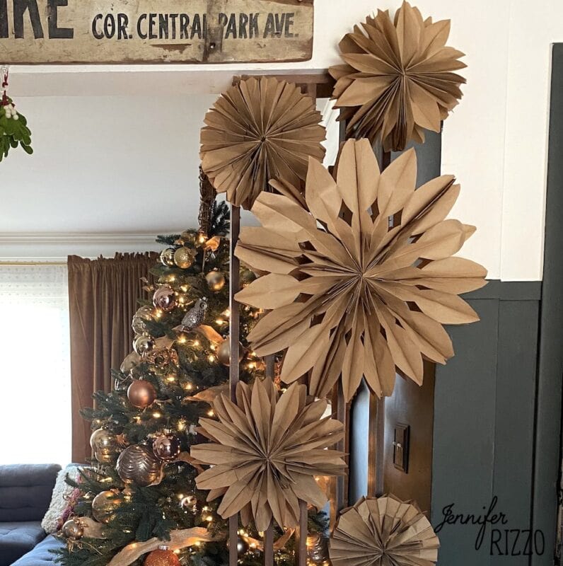 amazing and easy christmas craft paper ideas 4 different size paper bag snowflakes made from brown kraft bags on a wall