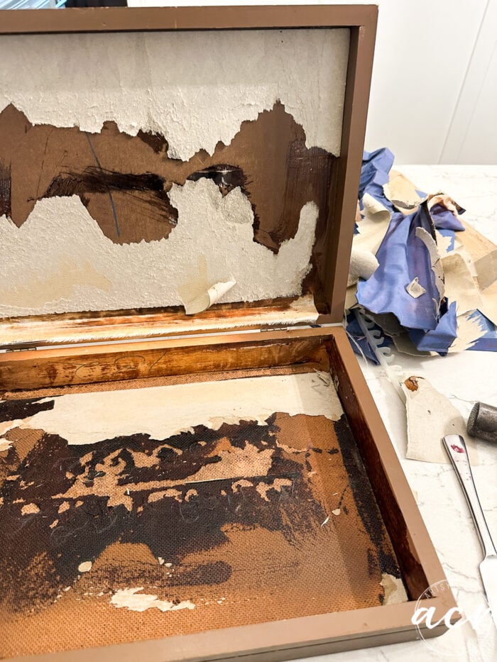 peeling away the cardboard under the fabric