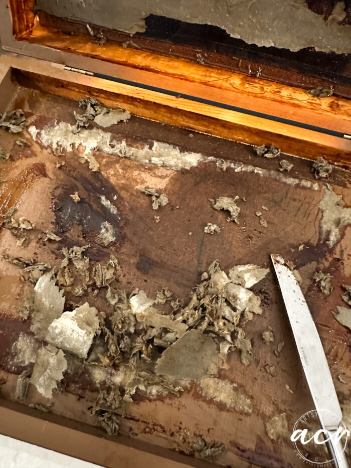 scraping the cardboard inside the box