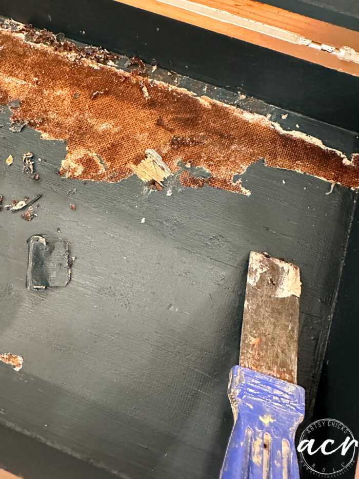 scraping up the painted bottom of flatware box