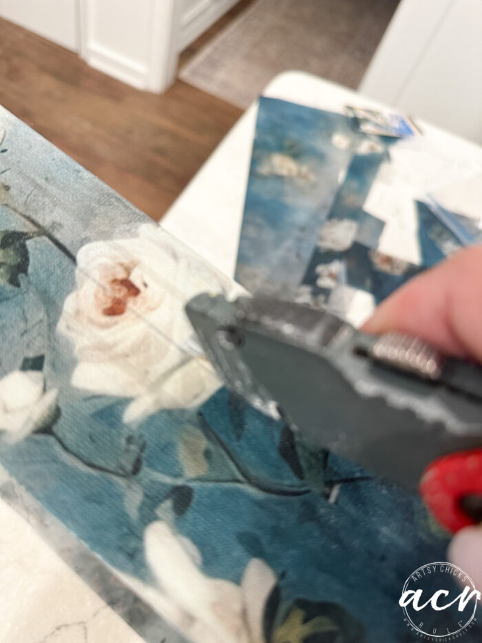 using a box cutter to cut line where opening is