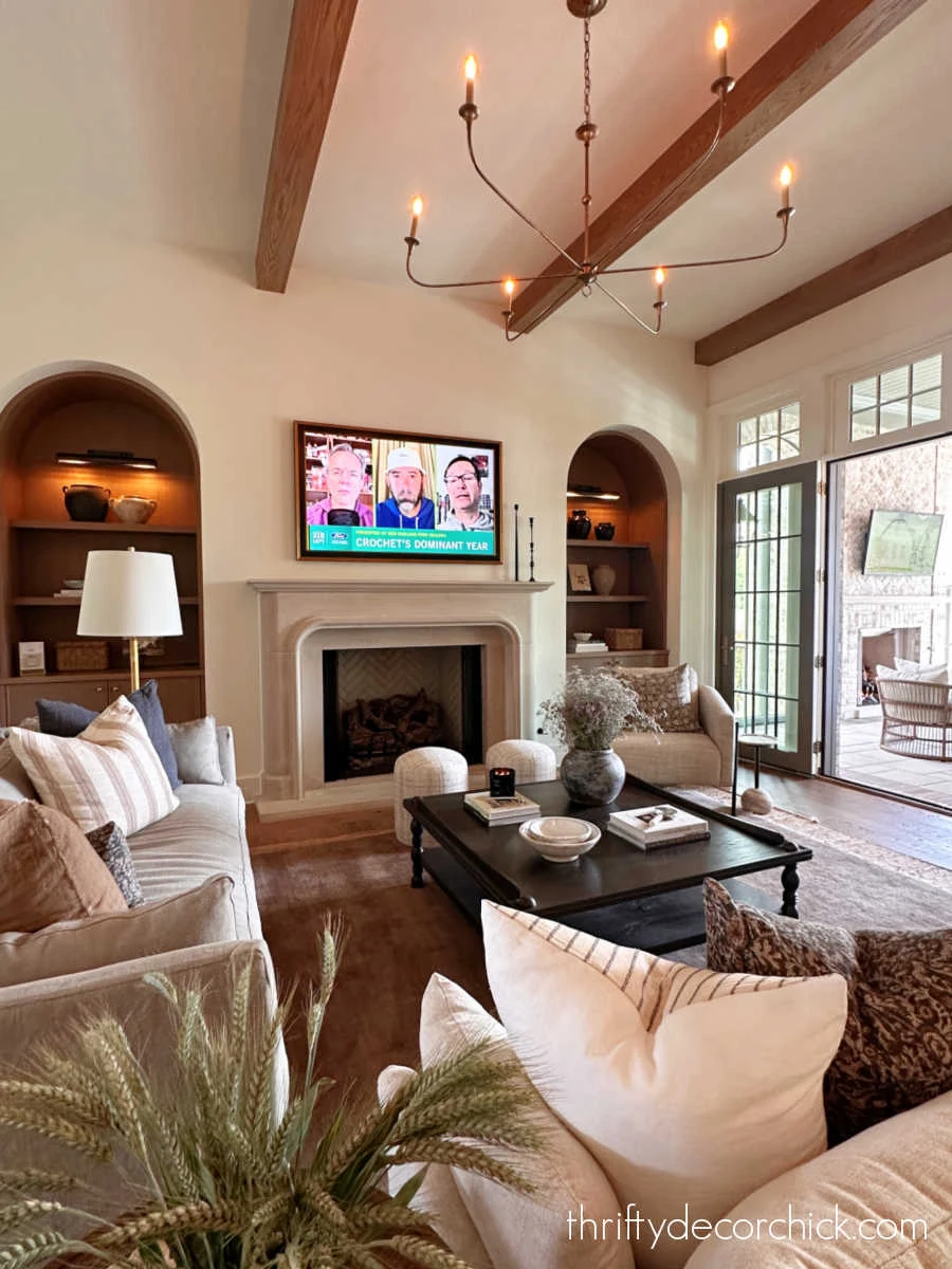 arched recessed bookcases by fireplace