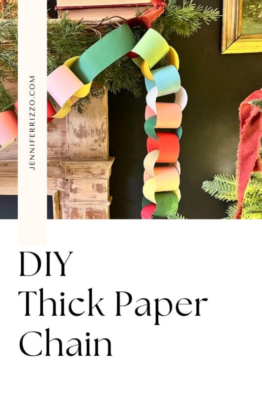 how to make an easy construction paper chain 10 a colorful, thick paper chain garland hangs on a mantel decorated with greenery and pine branches. text reads "diy thick paper chain.