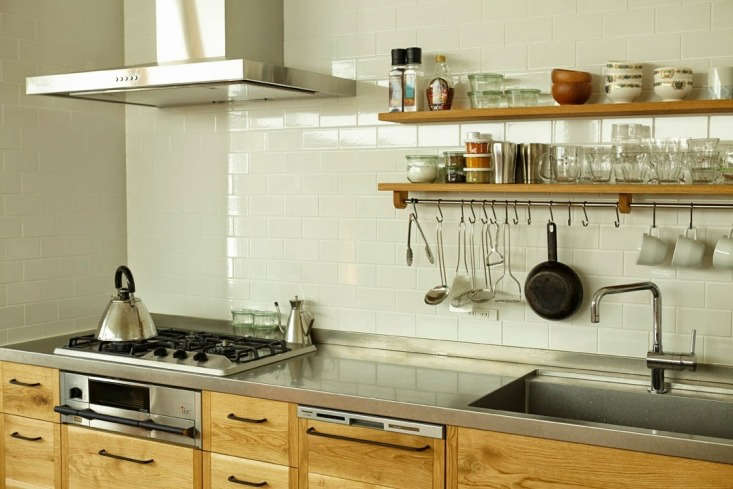 the kitchen has stainless steel counters—made by hand with a vibration finish 18
