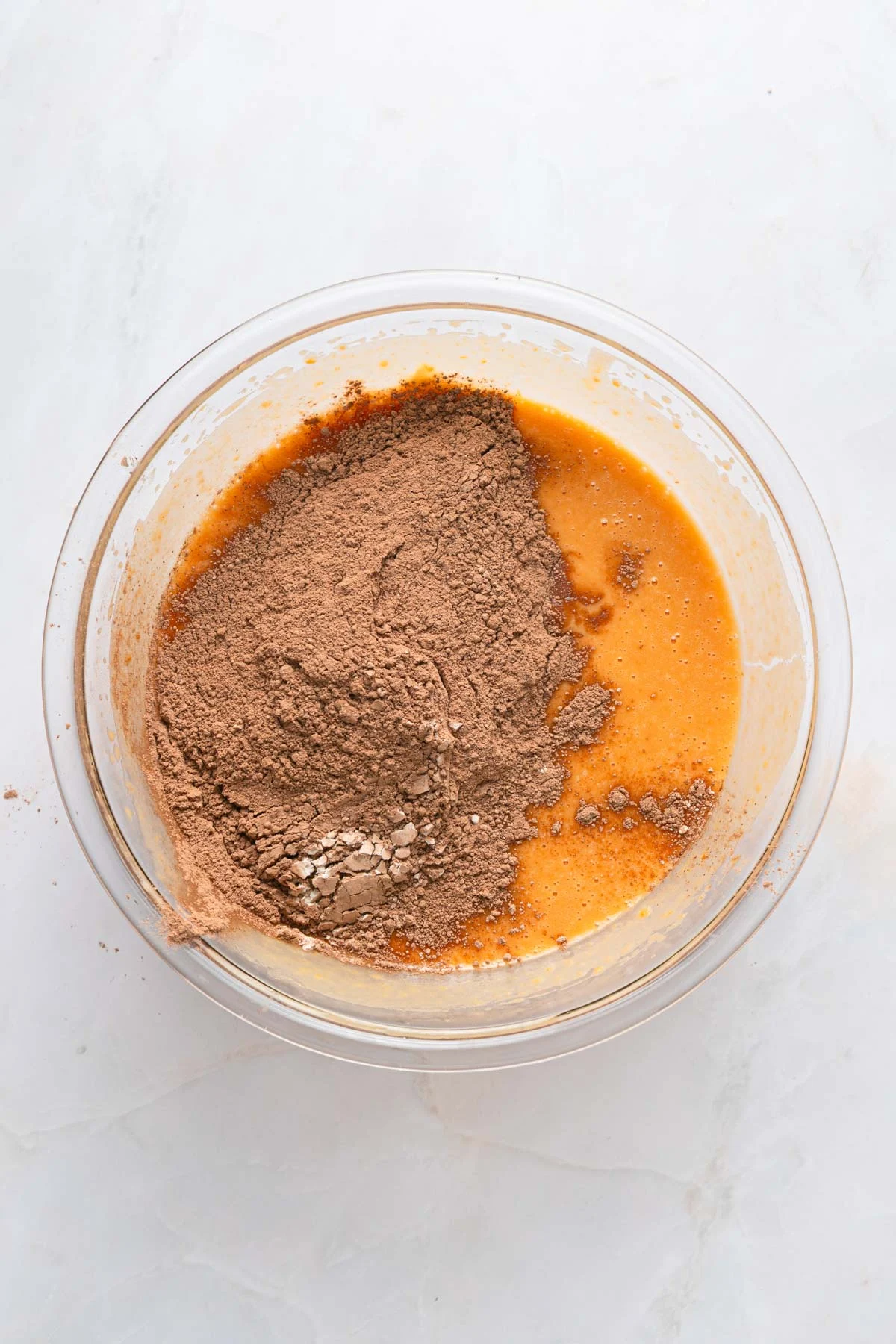 sweet potato brownies paper and stitch 5 ingredients being mixed in a bowl for brownies, cocoa powder, sweet potatoes, and more