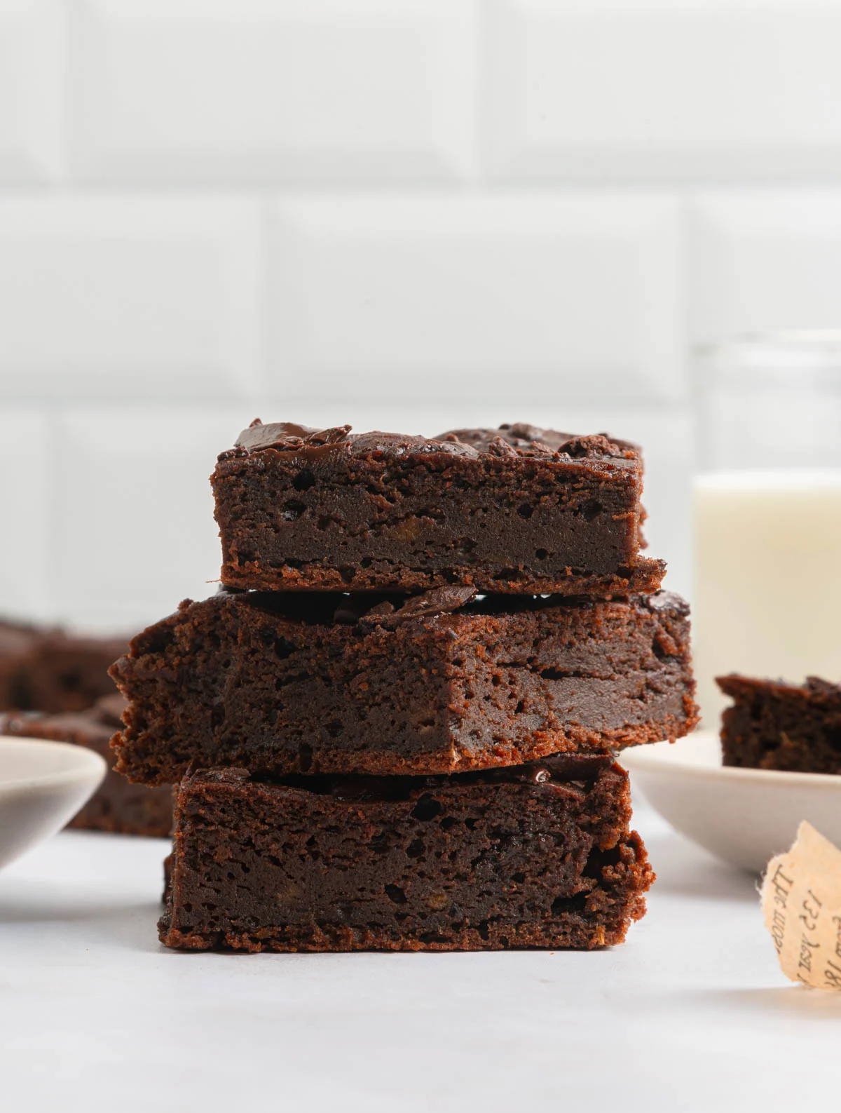 sweet potato brownies paper and stitch 12 fudge-y rich brownies stacked on top of each other in a white kitchen