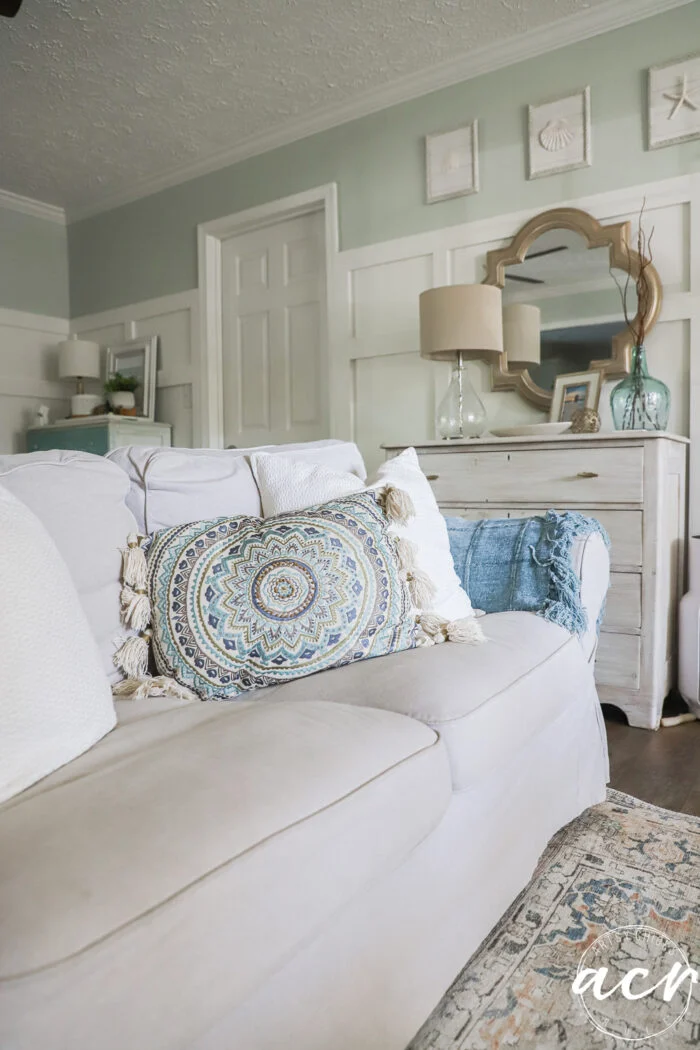 evolution of a living room 18 tan couch wwith blue and aqua decor pillow