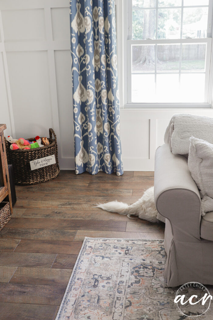 evolution of a living room 23 blue curtains and white dog tail sticking out from behind couch