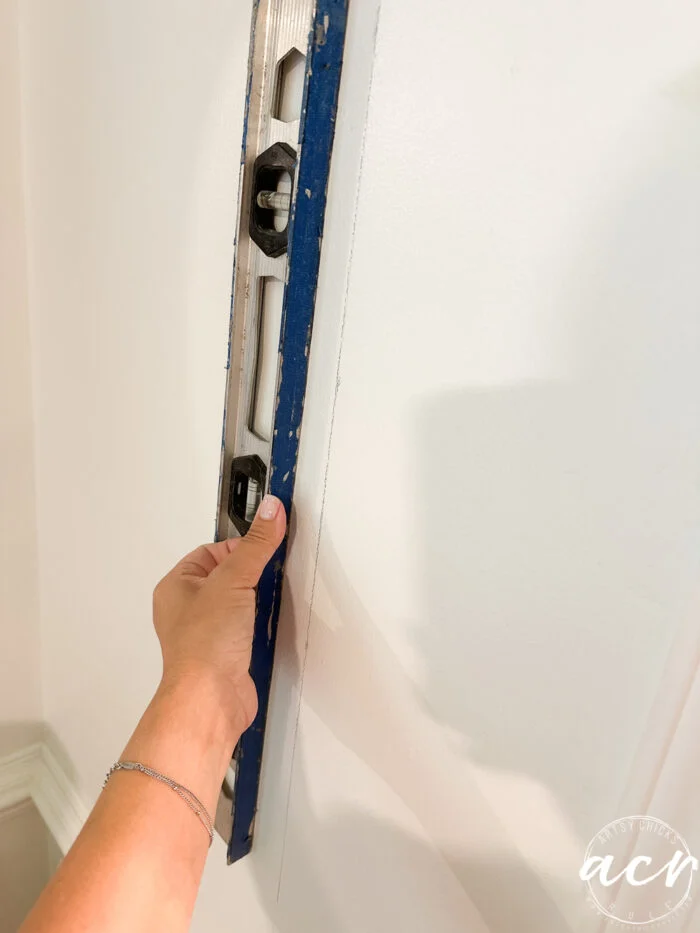 hanging prepasted strippable wallpaper artsy chicks rule 2 using level to make straight line