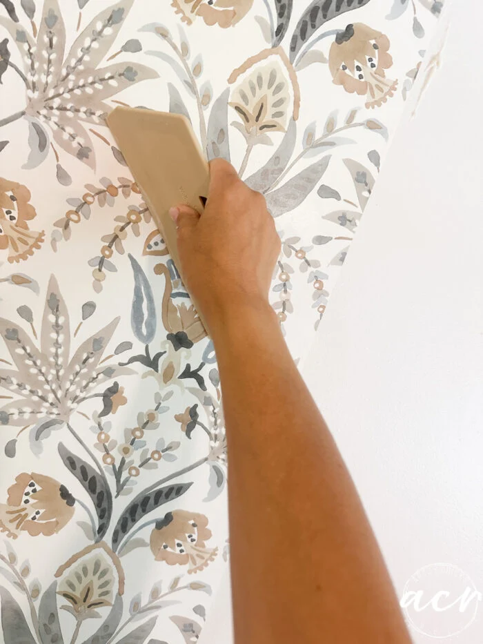hanging prepasted strippable wallpaper artsy chicks rule 10 using smoothing tool to smooth wallpaper