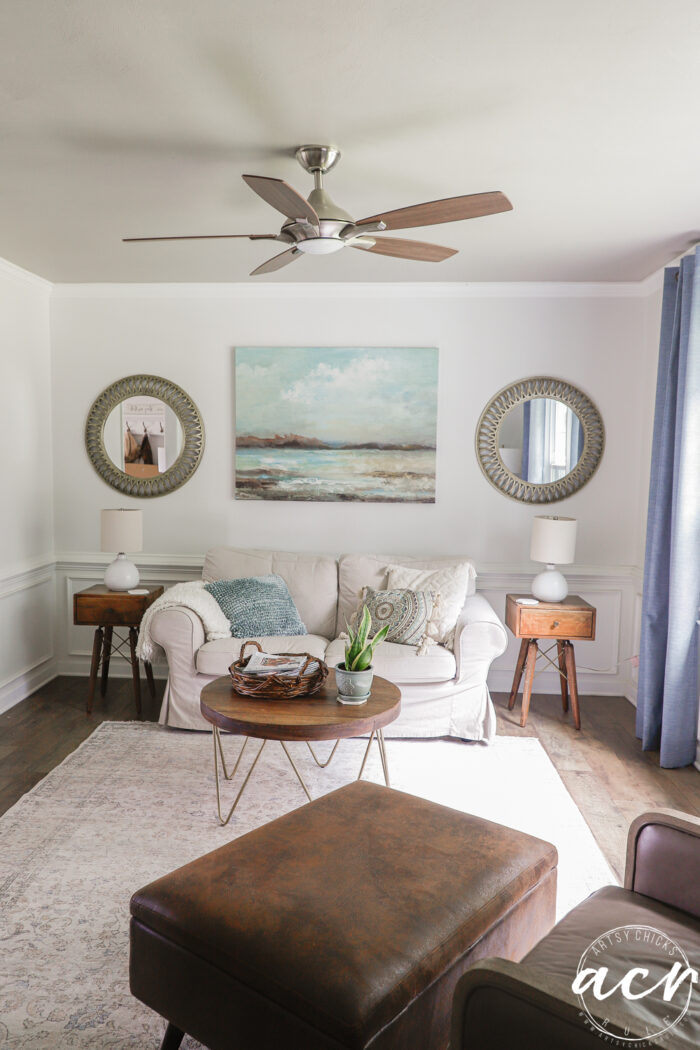 darker shade of brown/gray ceiling in room with couch and curtains 