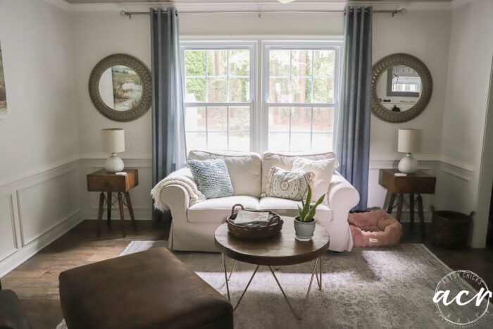 window with mirrors on each side and couch in front of window