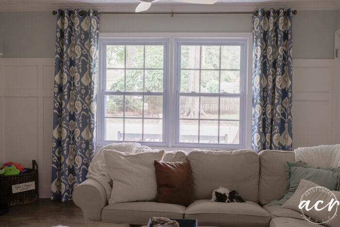 blue patterned curtains hanging around window