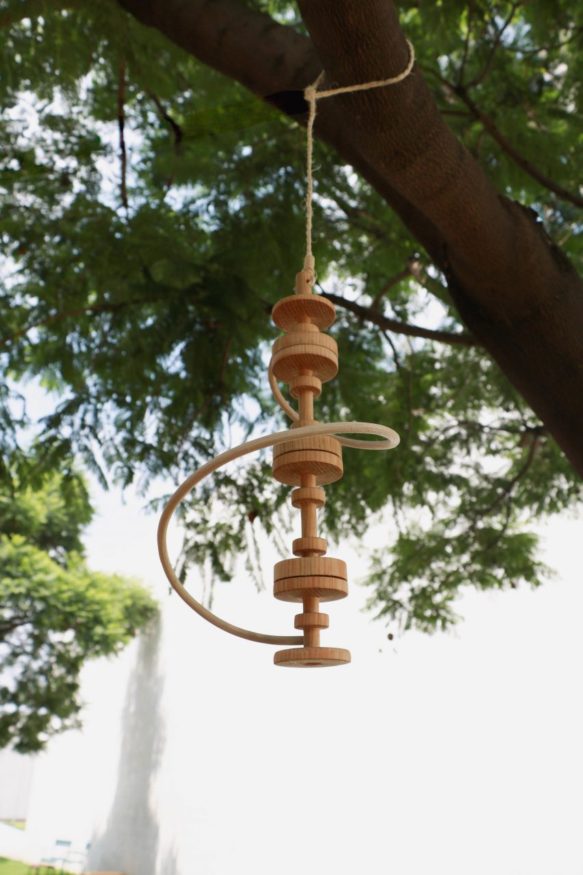 a photograph of a wooden ornament hanging from a tree