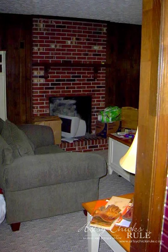 evolution of a living room 8 dark paneled walls, green couch and red brick fireplace