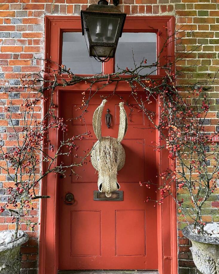 crabapple tree branches surround the festive front door of furniture designer maria le mesurier