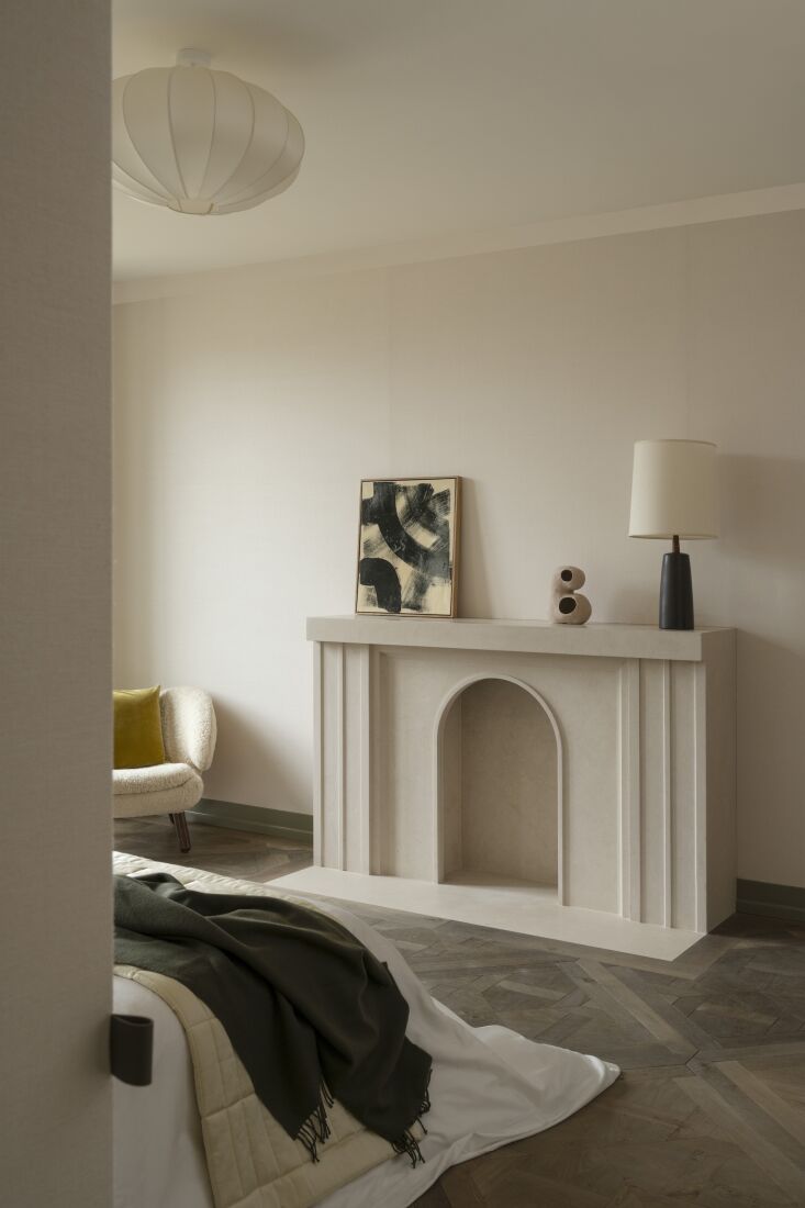 after bach worked with beige fine stone to cut a new sculptural mantle on which 20