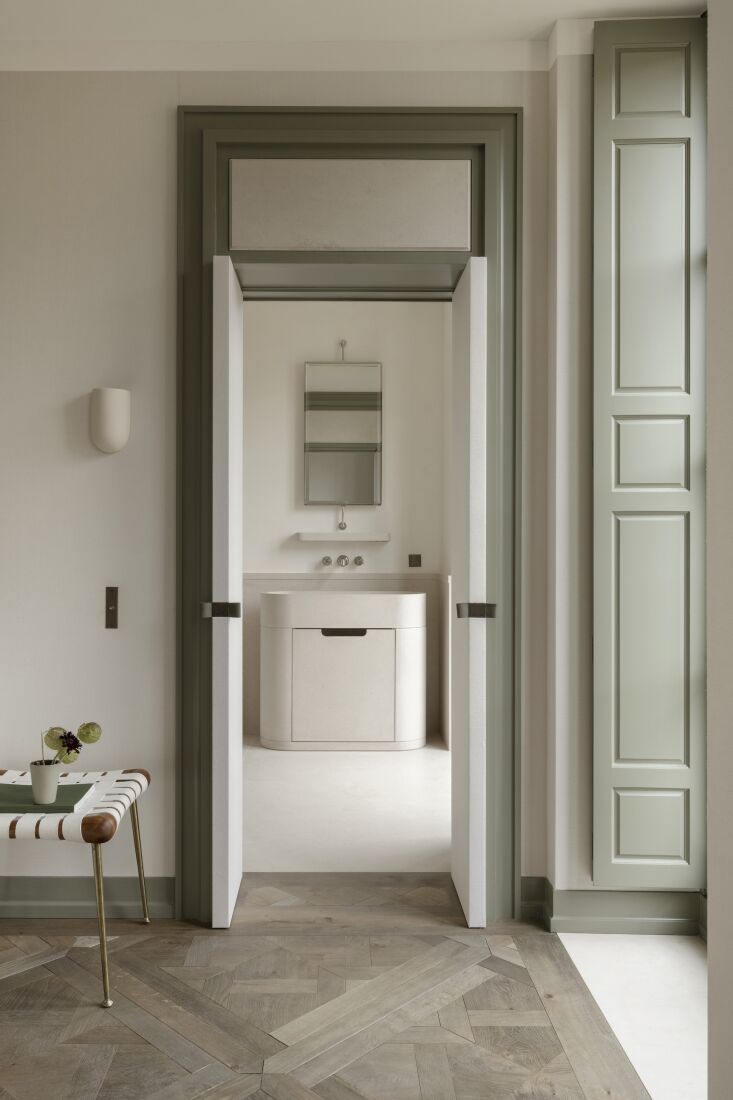 a look into the ensuite bathroom with a custom vanity paired with a waterworks  21