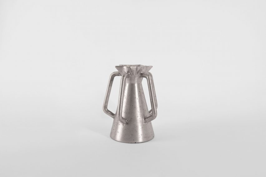 a silver jug with multiple handles