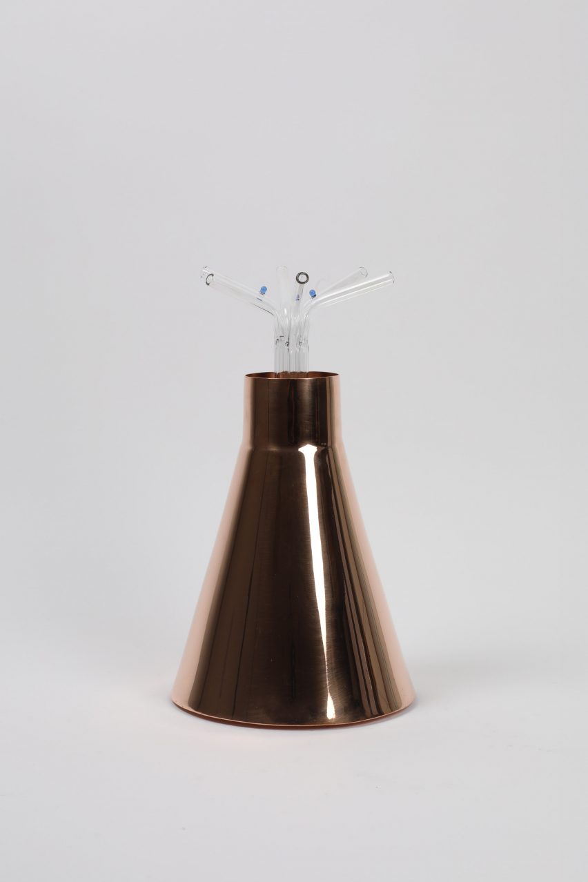 a copper cup with straws at the top