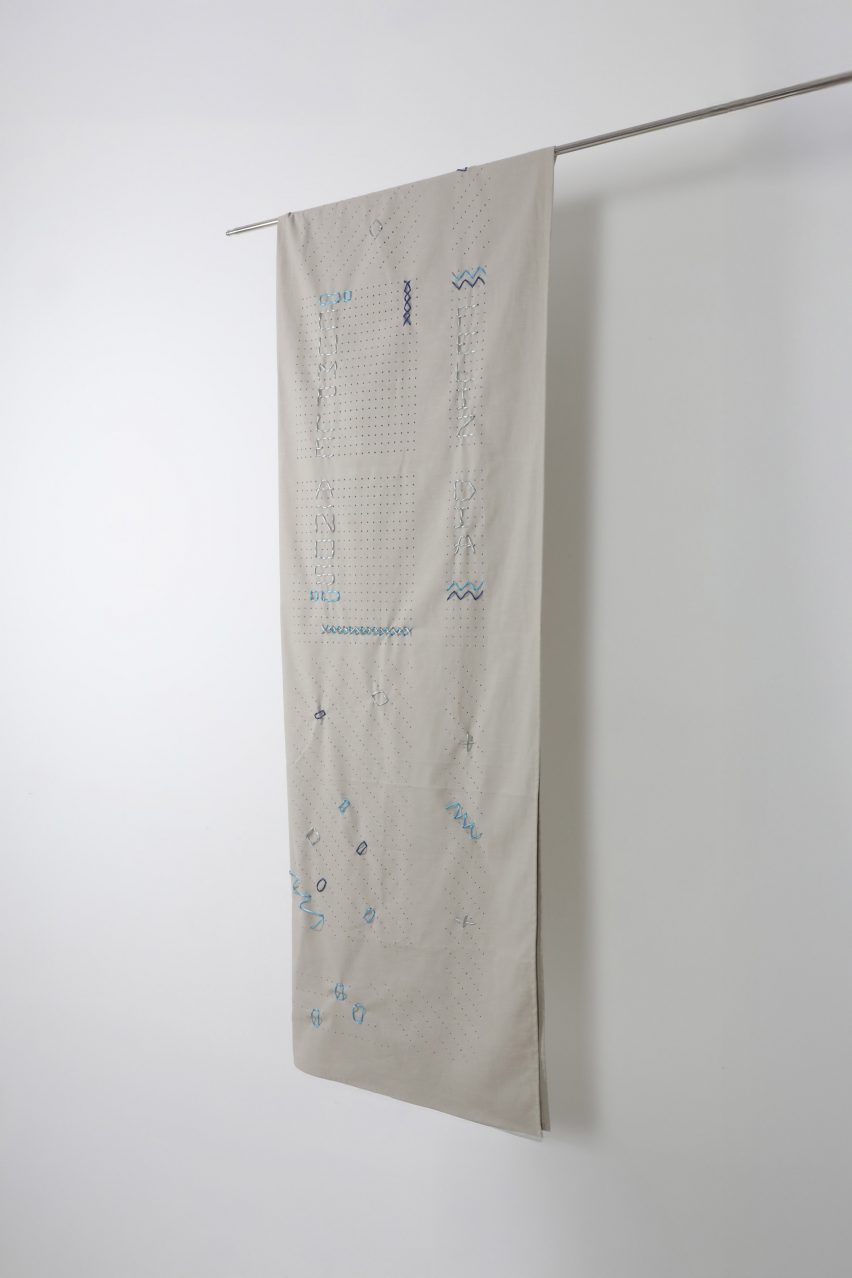 a hanging tapestry in tones of white and blue