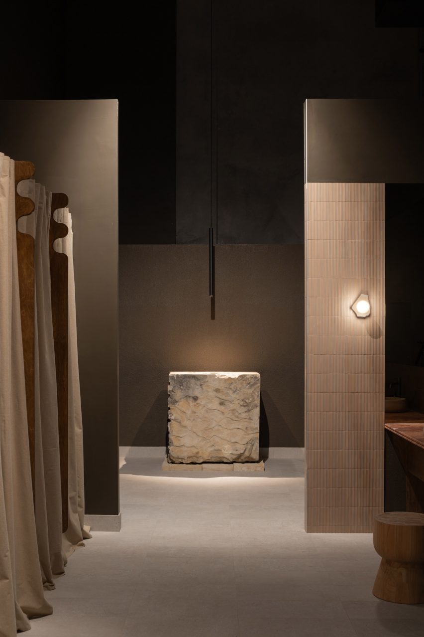 spa interior with large stone sink and stone offcut sconce lights