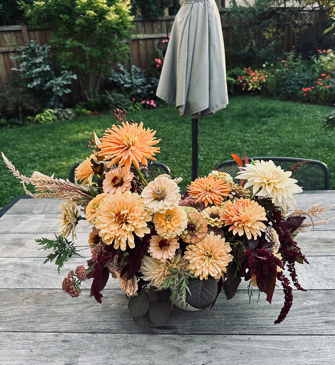 bouquet of light orange flowers and dark foliage