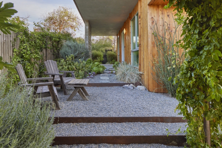 tiered gravel steps lead to a small sitting area. 