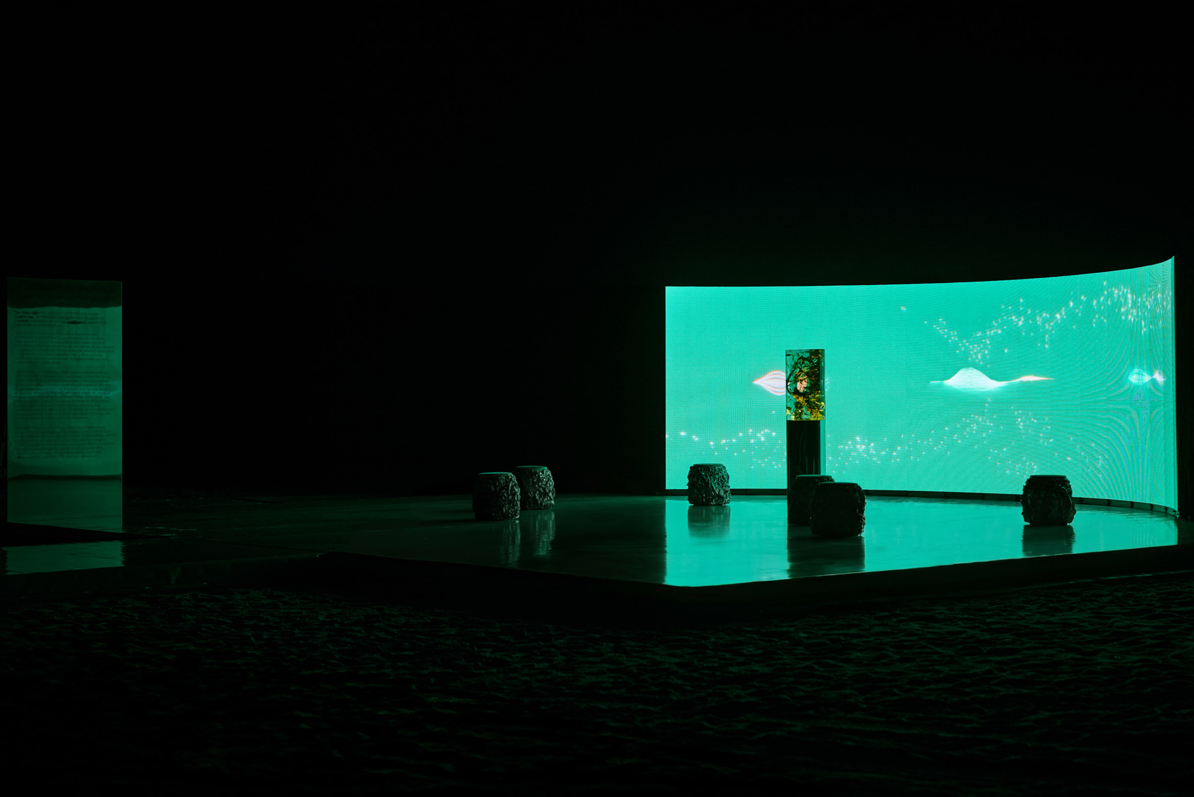 large curved led screen showing abstract pink light forms behind a central illuminated resin sculpture by marcin ruskin for perrier-jouët