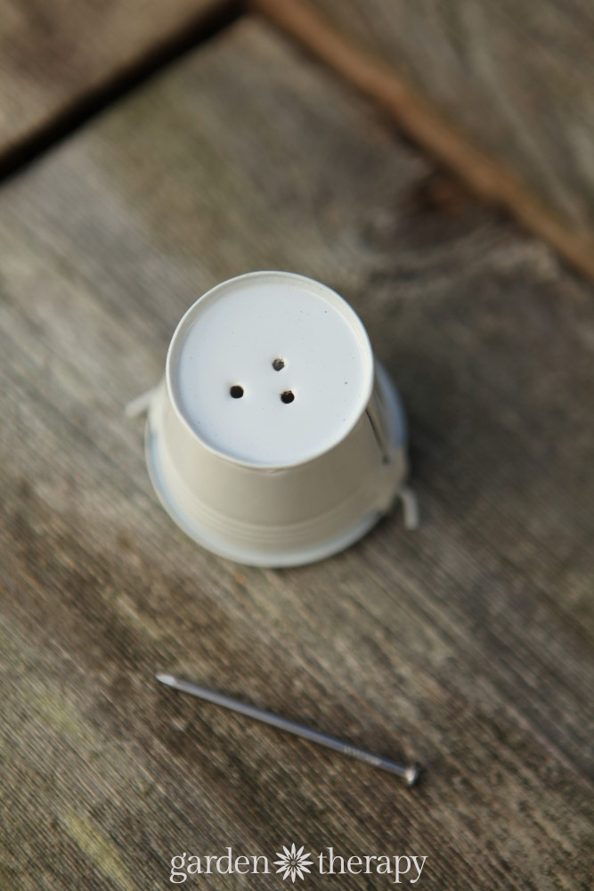 small white bucket with three holes in the bottom
