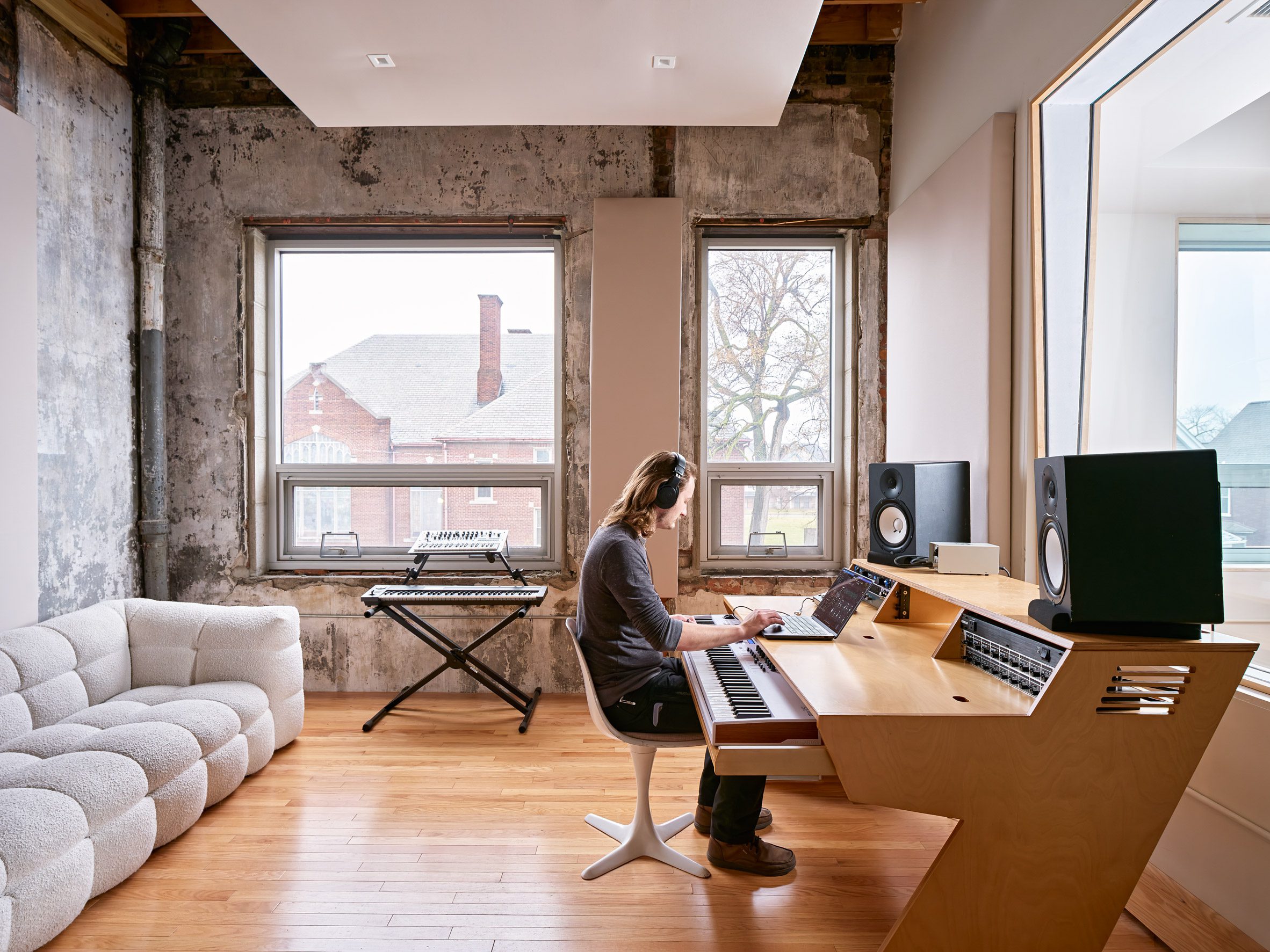 recording studio with a wooden desk and exposed concrete walls