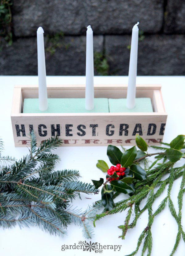 putting together a rustic christmas candle centerpiece 