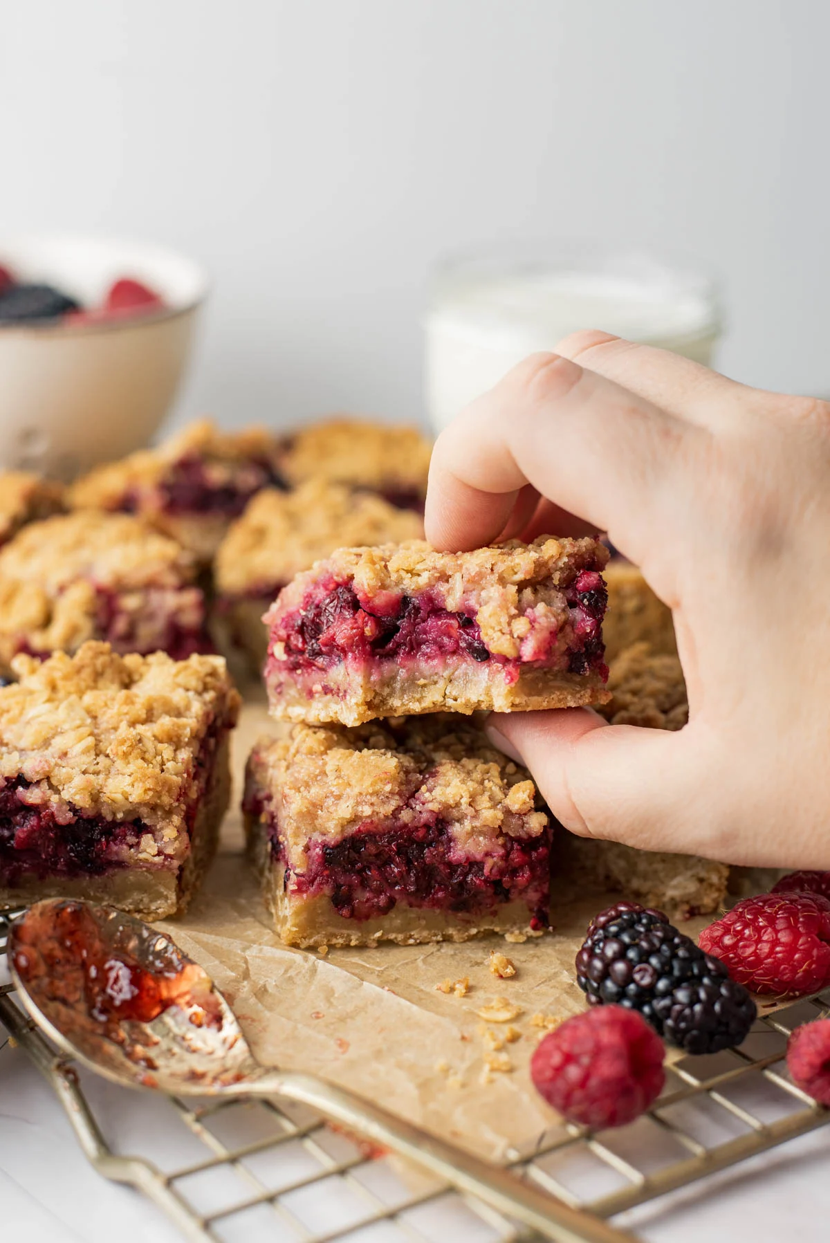 woman's hand picking up a small dessert bar