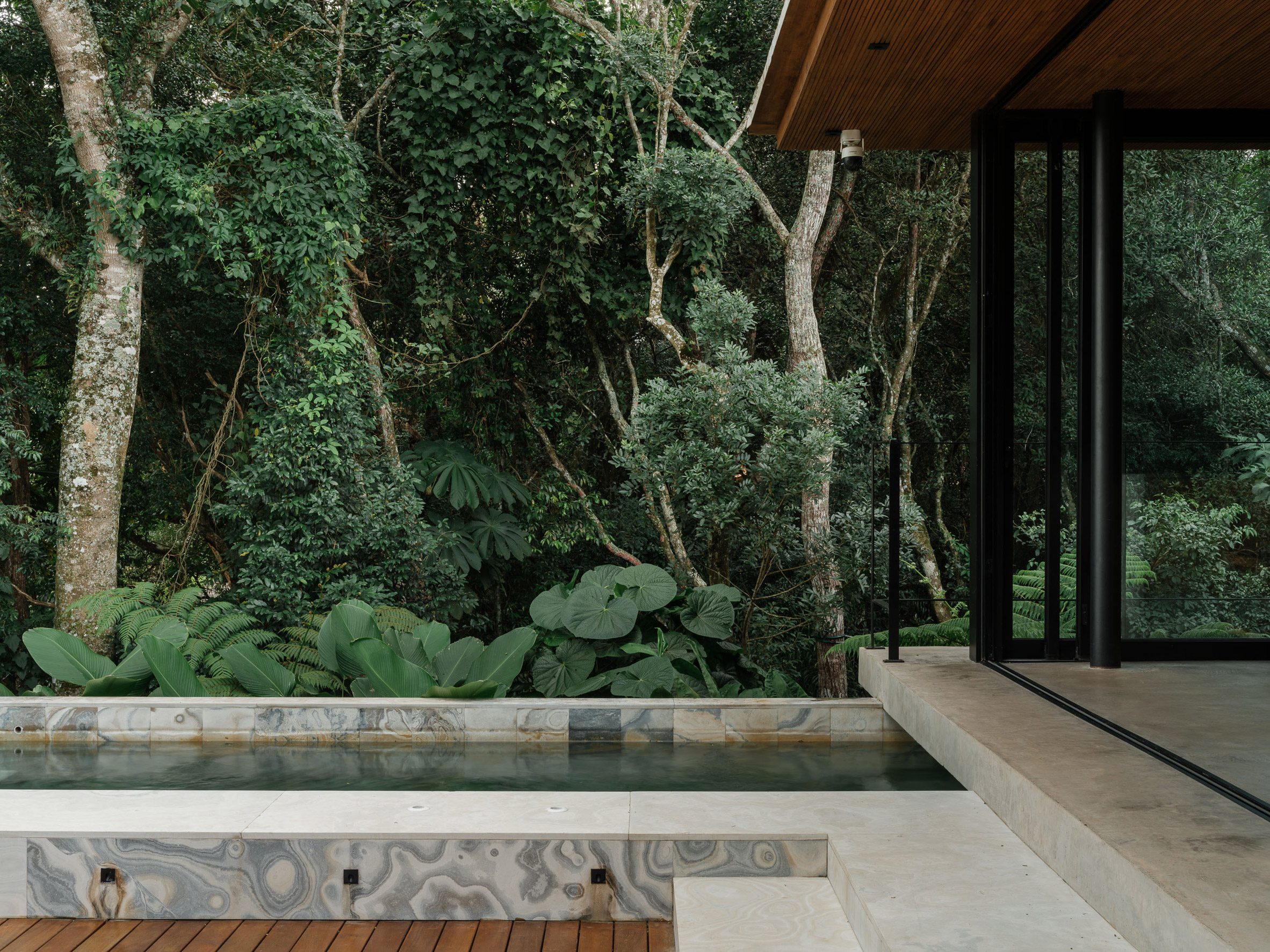 a swimming pool extends from one end of a modular building