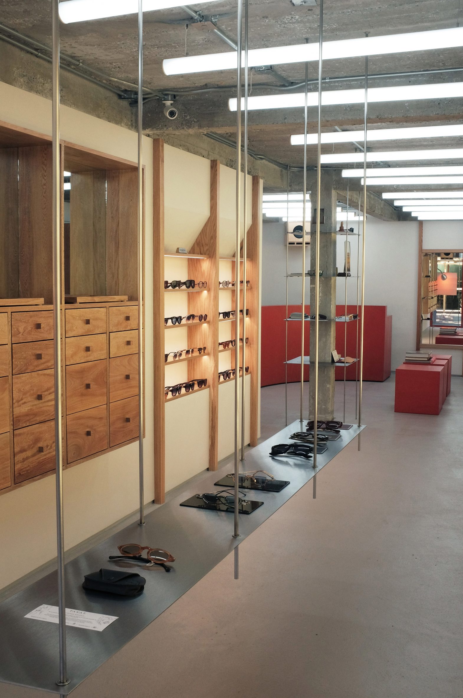 a long shelf hung from rods to display eyewear