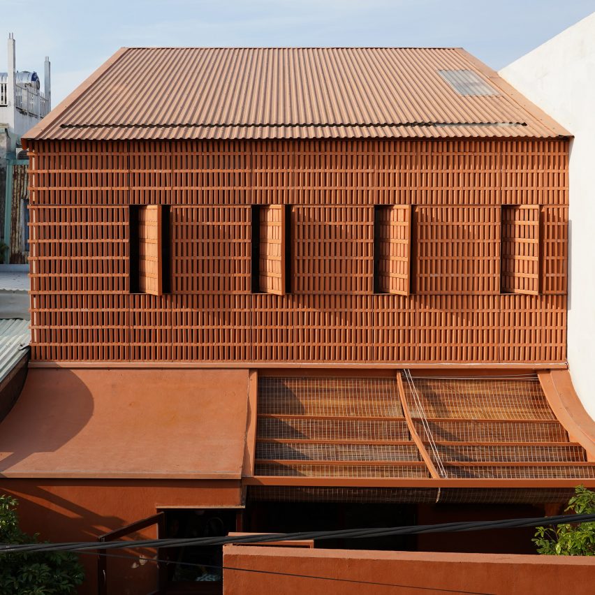 Perforated brick wall fronts breezy home in Vietnam by Live Out Studio