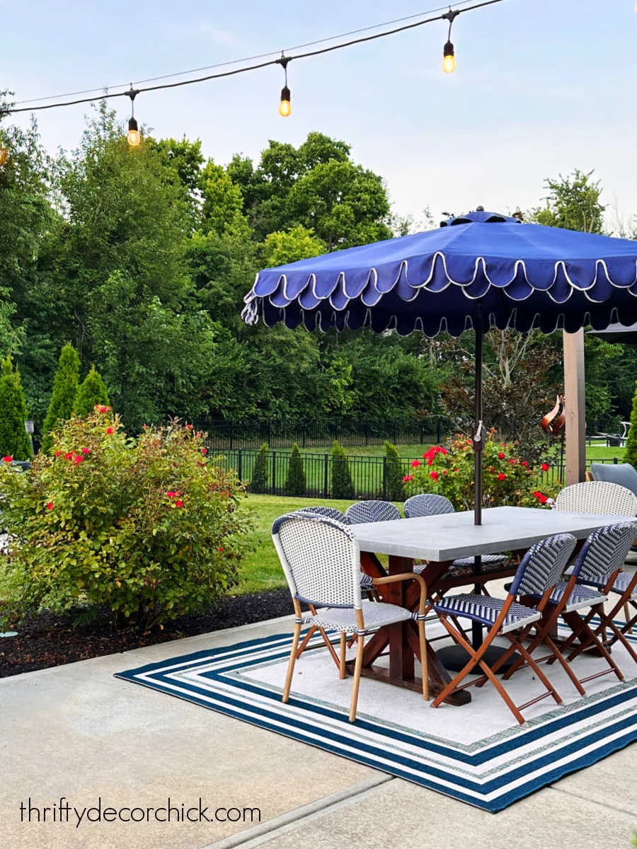 blue scalloped umbrella with table