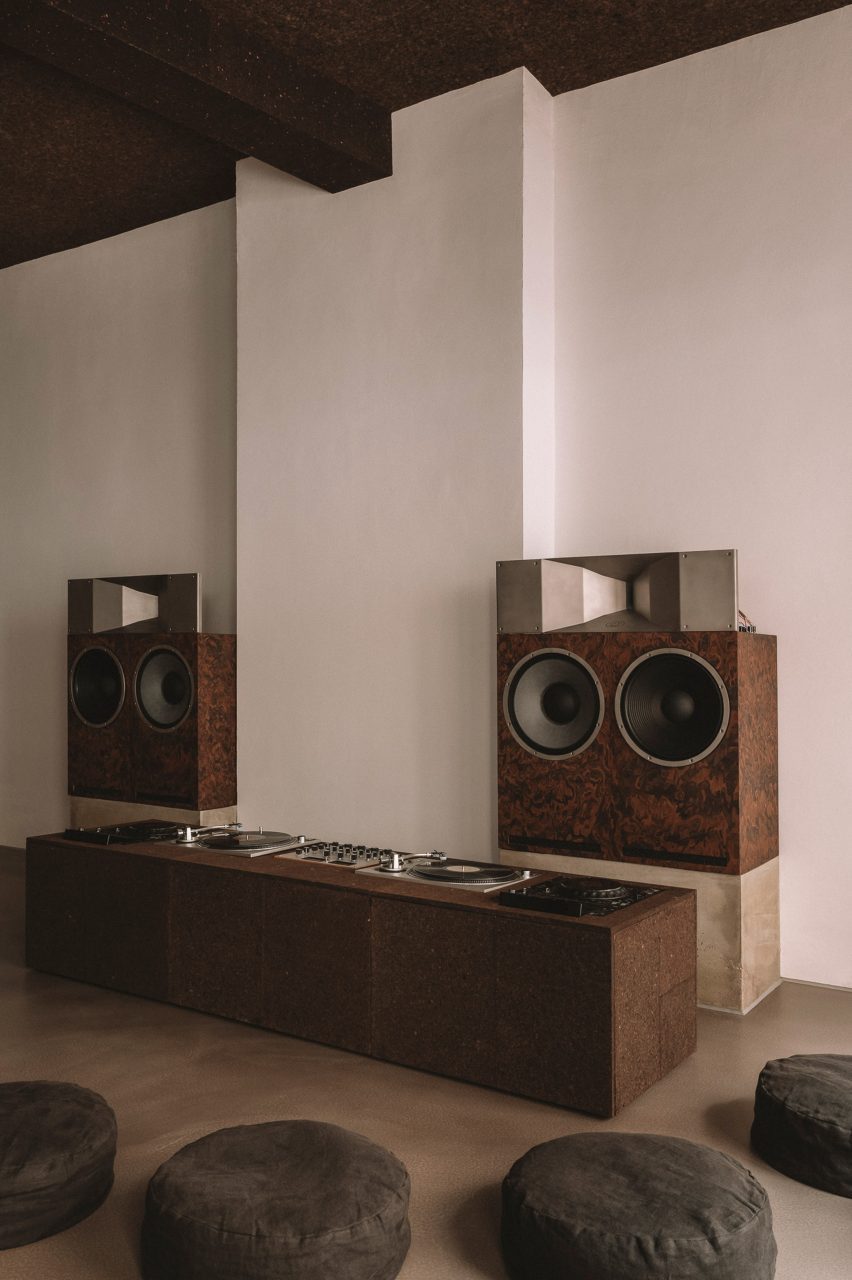 cork-clad dj booth and floor pillows inside trader hifi cafe in hamburg by vincent von thien