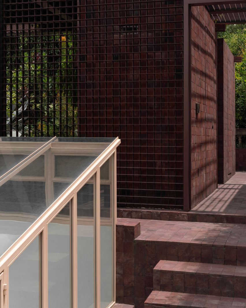 rooftop garden with surfaces covered in tiles made from dark red volcanic stone