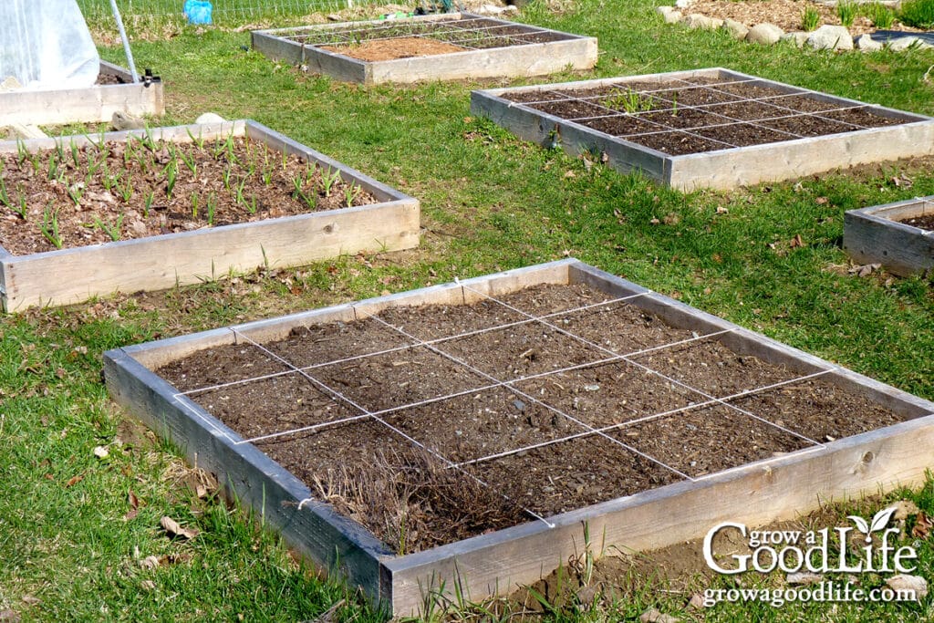 how to plan and map your beds 19 empty square foot garden beds neatly divided into grids and ready for spring planting.