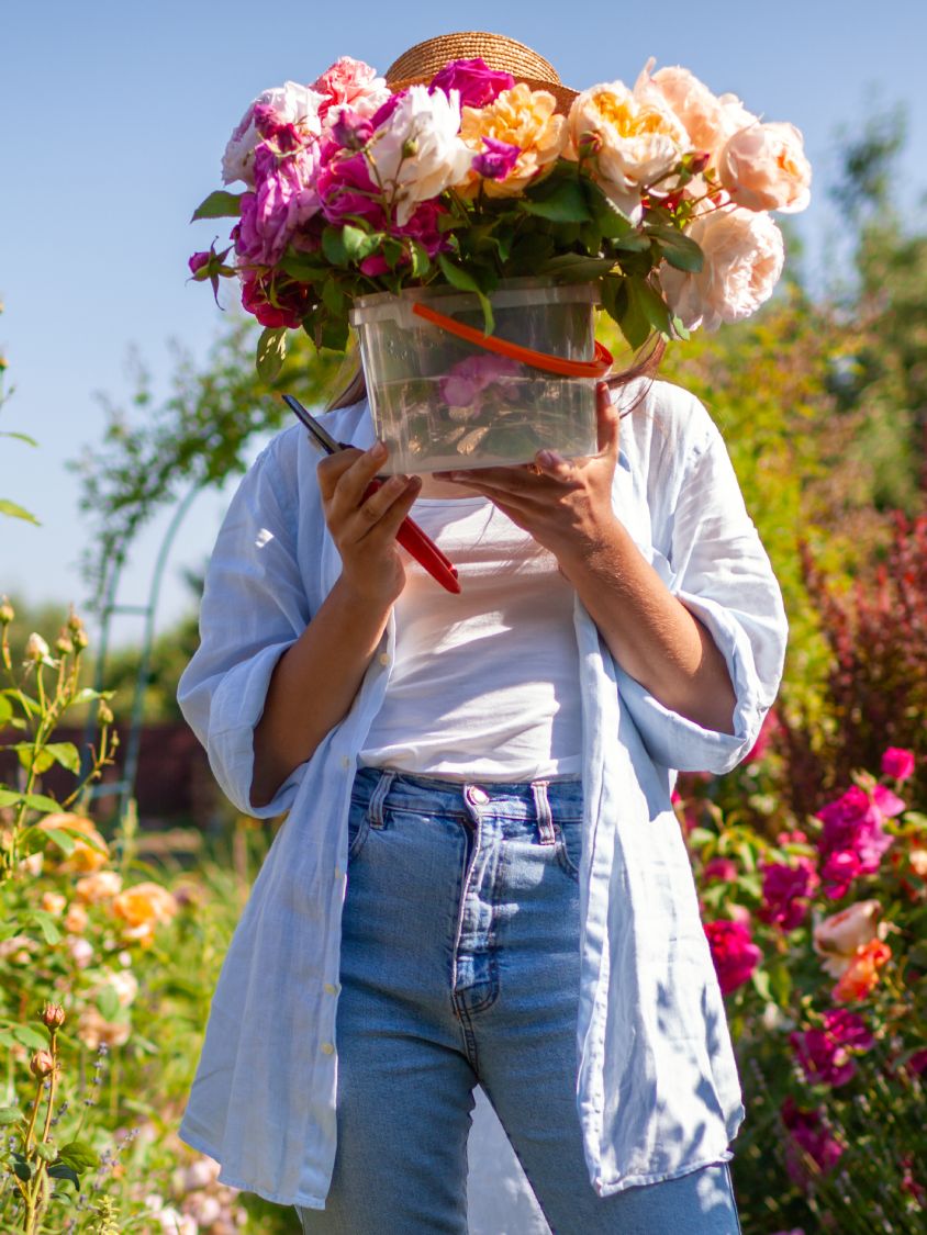 given up on your new year’s resolution? try these instead 3 woman holding a bucket of cut roses in a garden