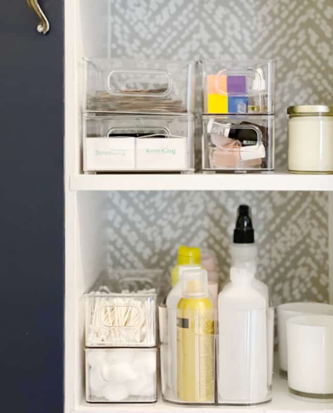 10 unexpected organizing ideas you may not have thought of 10 how to organize: organized bathroom shelf with labeled containers and neatly stored personal care items against a patterned wallpaper background.