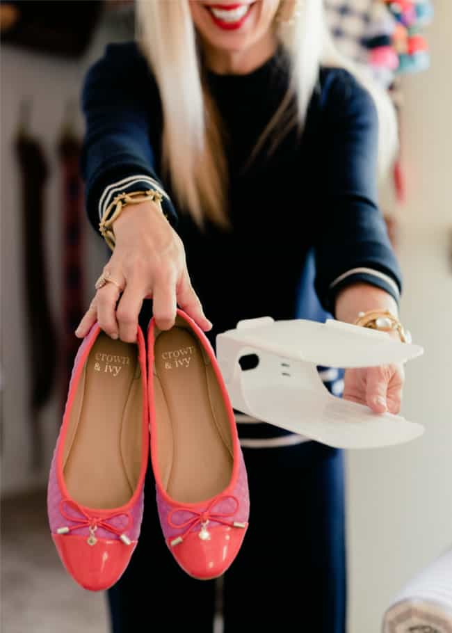 10 unexpected organizing ideas you may not have thought of 17 a smiling woman is holding a pair of red ballet flats and a virtual reality headset, suggesting a mix of traditional fashion and modern technology.