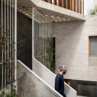 bureau de change enlivens apartment block with pink panels 2 infill block courtyard
