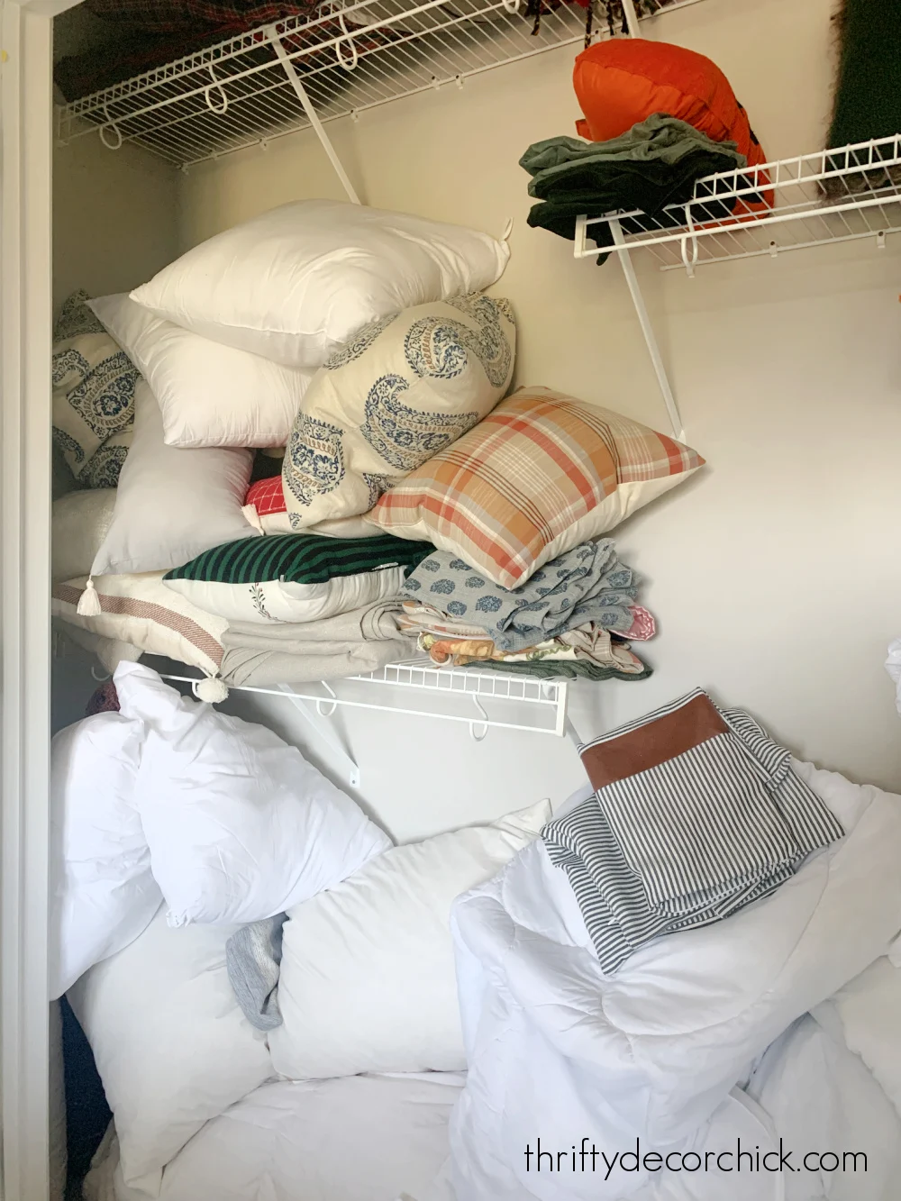 my top five tips that make decluttering much easier | thrifty decor chick 3 pile of pillows in closet