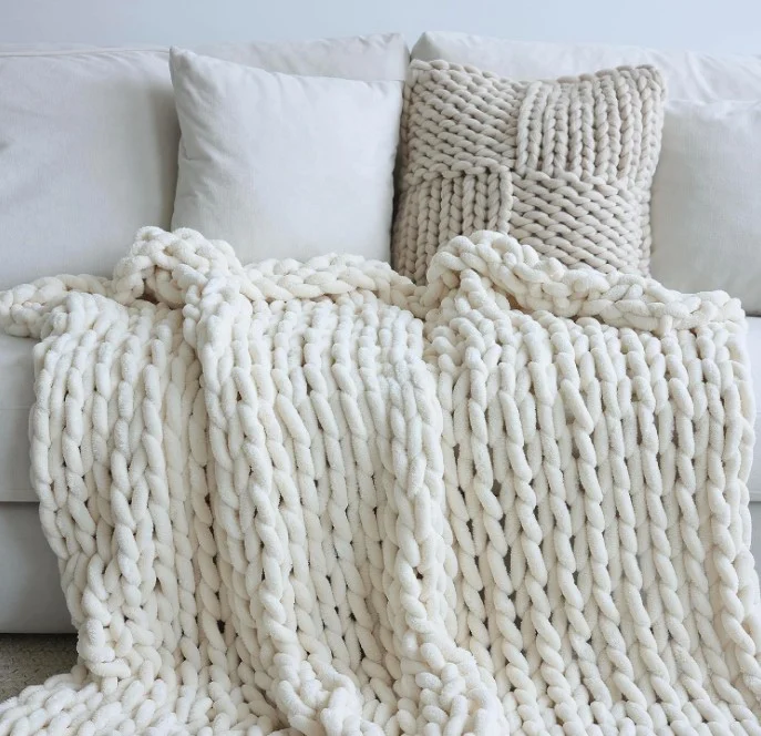 knitted looking throw on couch with pillows