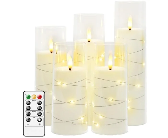 varying height group of glass candles with flameless lights and wrapped in fairy lights