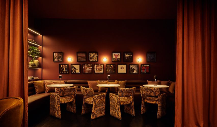 a cosy niche with wraparound seating tucked behind curtains